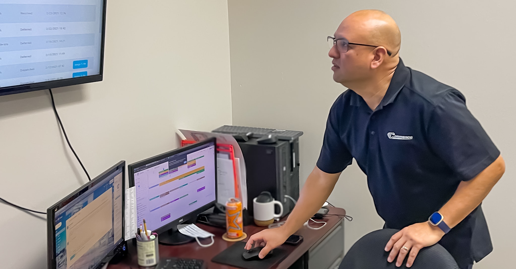 Ralph Aguilar, Commenco Technical Services Manager monitors network traffic on digital board
